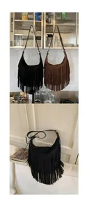 Detail shot of vintage hobo bags featuring long tassels in black and dark brown suede