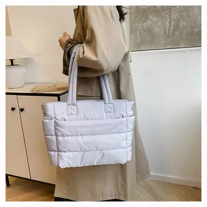 Quilted puffer tote bag in light grey nylon with padded straps for daily commute