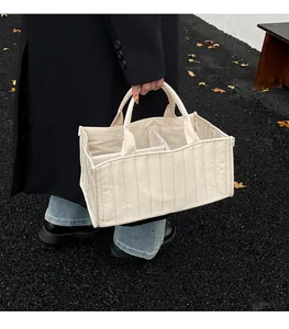 Close-up of beige quilted tote bag interior compartments for organized storage