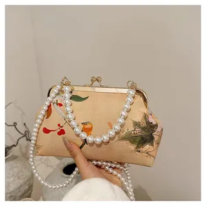 Close-up of vintage pearl chain clasp bag with Chinese floral and bird painting prints