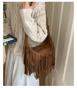 Bohemian brown suede tassel crossbody bag worn by model in cozy autumn sweater