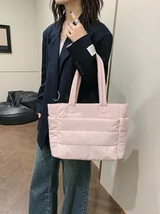 Light pink quilted down tote bag for women showing its large capacity and puffy texture