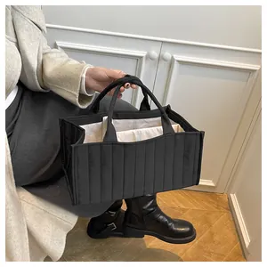 Detailed view of the black quilted tote bag showing multi-compartment interior and lining