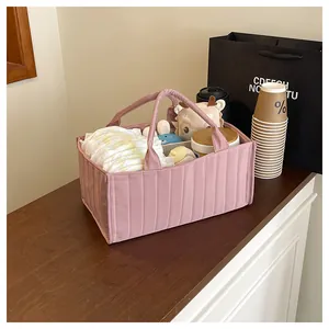 Detailed interior of a pink quilted diaper caddy tote with organized baby essentials