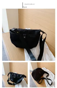 Detailed views of a black Oxford cloth crossbody bag with adjustable wide strap and metal accents