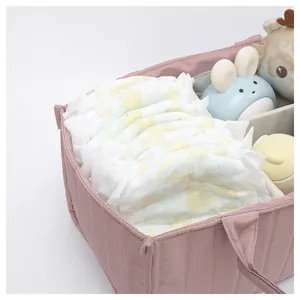 Close-up of pink quilted diaper tote bag showing organized interior dividers and large capacity