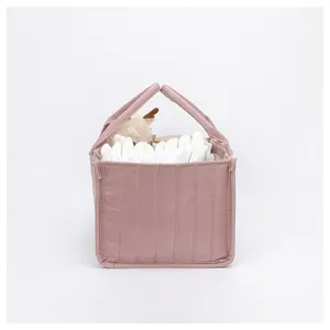 Detailed view of pink quilted diaper tote bag showing spacious storage for baby essentials