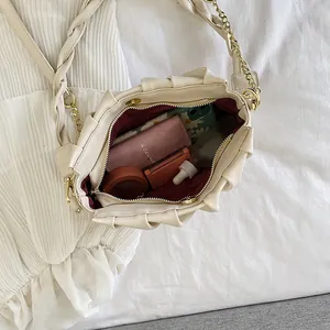 Chic beige pleated cloud handbag with gold chain strap and spacious interior