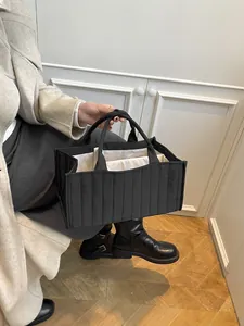 Minimalist black quilted tote bag with large capacity for commuting and daily storage