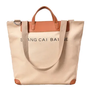 Minimalist canvas tote bag with brown leather handles and large capacity storage