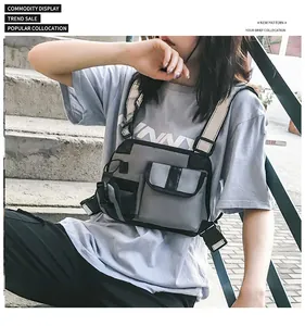 Detail of grey tactical chest rig with multi-pocket design and adjustable buckle straps