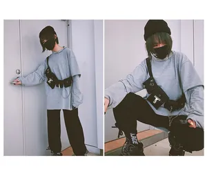 Streetwear style tactical chest bag with metal chain and multiple pockets on grey top