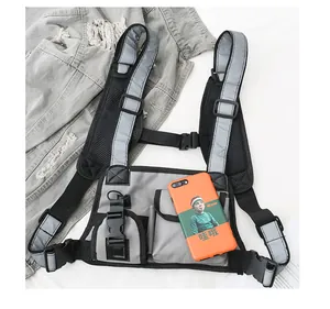 Detail of reflective tactical chest bag featuring adjustable straps and high-visibility strips