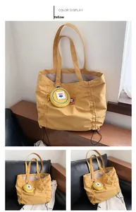 Detail of yellow canvas tote bag with drawstring side and floral pattern coin purse