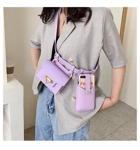 Detail of lavender purple mini crossbody bag and phone pouch worn by a model in casual blazer