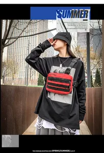Outdoor street style shot of a red nylon shoulder bag with fashion strap and buckle