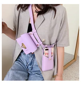 Detail of lavender crossbody bag set with gold lock and matching phone pouch on gray blazer