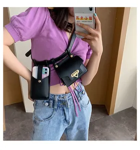 Detail of black waist bag set with gold triangle buckle and vertical phone pouch