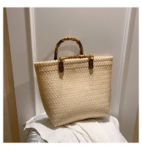 Detail of hand-woven beige bag with bamboo handle and high-quality leather buckles