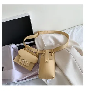 Detail of beige leather waist belt bag set with metallic triangle buckle and dual pouches