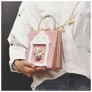 Pink vintage shoulder bag with cherub relief and elegant pearl gold chain strap
