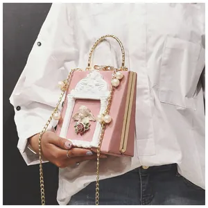 Detailed macro of vintage Baroque pink handbag with angel relief and pearl chain strap