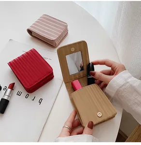 Detail view of mini PU leather lipstick pouch with mirror and magnetic closure flap