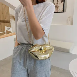 Fashionable gold lip shaped hardshell crossbody bag with elegant gold metal chain strap