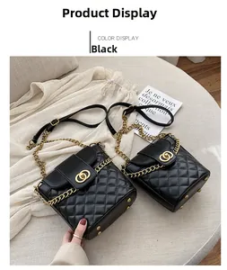 Detail of black quilted bucket bag featuring gold clasp and protective bottom studs