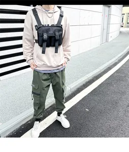 Tactical chest bag worn by a model in a street style setting with black functional pockets