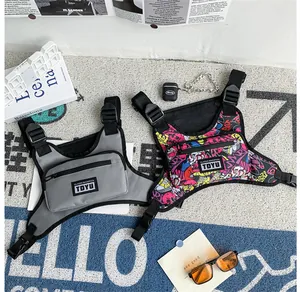 Detail of tactical chest bags in grey and graffiti print with adjustable straps and buckles