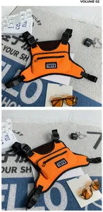 Detail of vibrant orange nylon chest rig bag with adjustable black straps and buckles