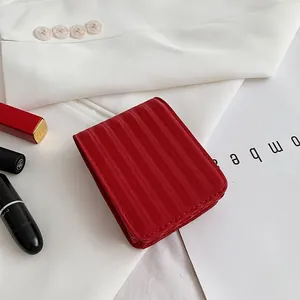 Mini red textured flip makeup bag with magnetic closure for lipstick and mirror