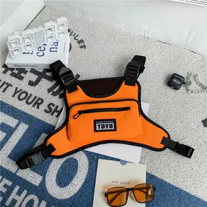 Streetwear bright orange chest rig bag with black adjustable straps and classic backpack label