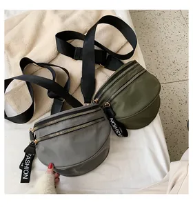 Detail of grey and olive nylon waist bags with double zippers and fashion webbed pullers