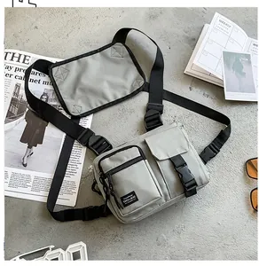 Detailed view of grey canvas tactical chest bag with multi-pockets and nylon straps