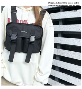 Close-up of black tactical chest bag with plastic buckles and chestbag logo on white hoodie