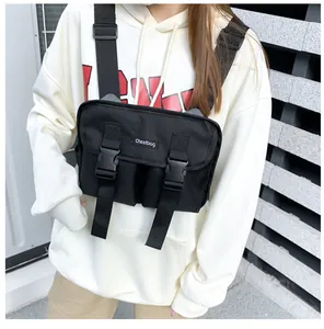 Close-up of black tactical chest bag with dual buckle closures and adjustable straps