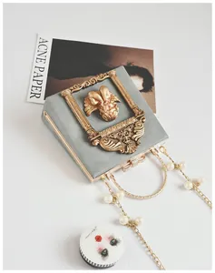 Grey vintage square bag with gold angel relief frame and decorative pearl chain strap