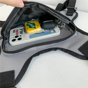 Tactical grey and black chest bag showing internal storage for phone and accessories