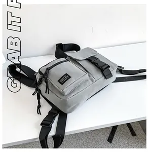 Detail view of the gray canvas crossbody bag with TDYU+BAG logo and quick-release buckle
