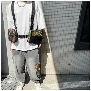 Macro shot of tactical chest bag with dual pockets in woodland camouflage pattern