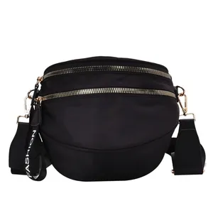 Minimalist black nylon crossbody chest bag with double zippers and Fashion ribbon detail