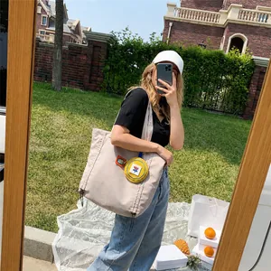 Minimalist beige canvas tote bag with a small yellow round wallet for women