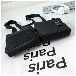 Detail of black tactical sling bag featuring breathable mesh pocket and metal D-rings