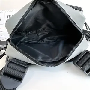 Fashionable sporty grey and black crossbody chest bag with adjustable strap and main pocket