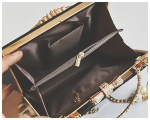Detail of evening clutch with brown fabric interior, gold hardware and diamond bow clasp