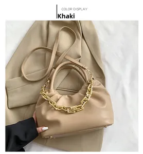 Detail of khaki pleated cloud bag featuring matte gold chain and premium PU leather