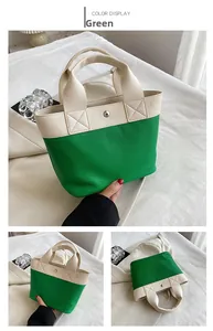 Dettaglio della borsa tote color-block con bottone magnetico e cuciture a X rinforzate