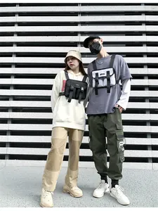 Outdoor street fashion shot of adjustable tactical chest bags in black and grey nylon